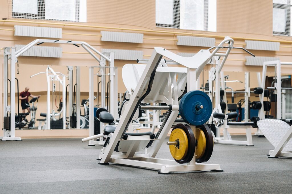 bright gym. Sports equipment in the gym. Bars of different weights on the rack.Trainers